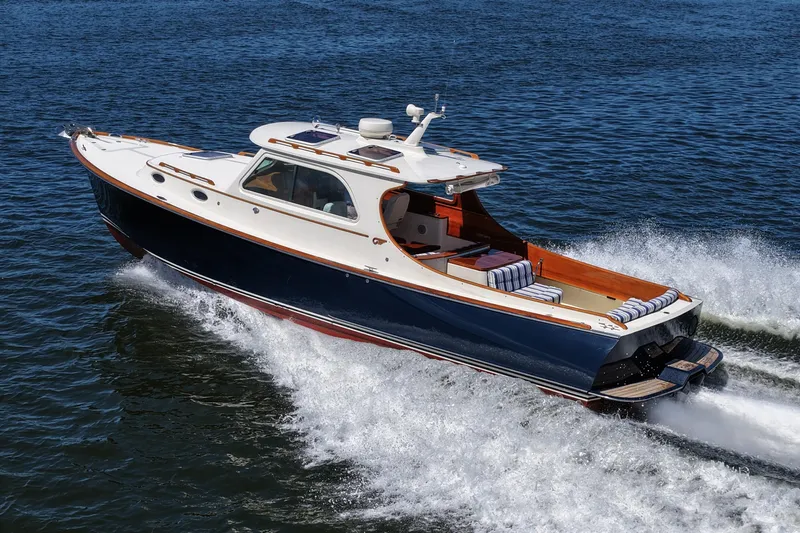  Yacht Photos Pics Hinckley 36 yacht cruising on water, 2005 model, elegant design, blue and white exterior.