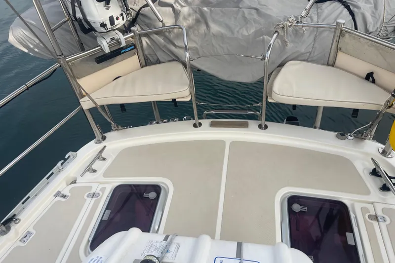 Peetee Hana Yacht Photos Pics 2008 Caliber center cockpit cutter deck with seating and covered equipment.