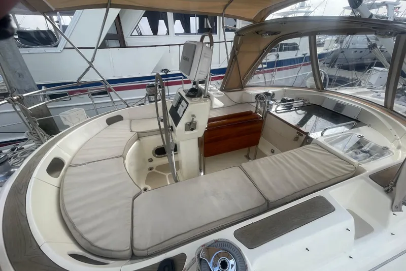 Peetee Hana Yacht Photos Pics 2008 Caliber center cockpit cutter with cushioned seating and navigation equipment.