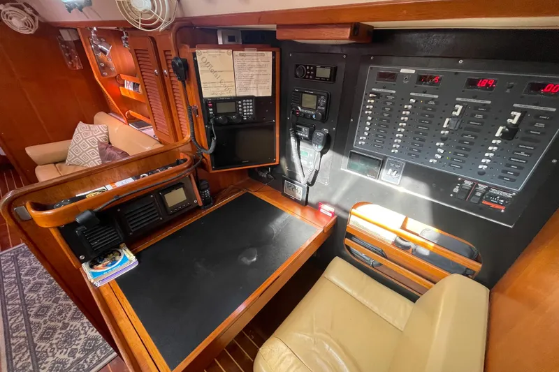 Peetee Hana Yacht Photos Pics Navigation station of 2008 Caliber center cockpit cutter with control panels and seating.