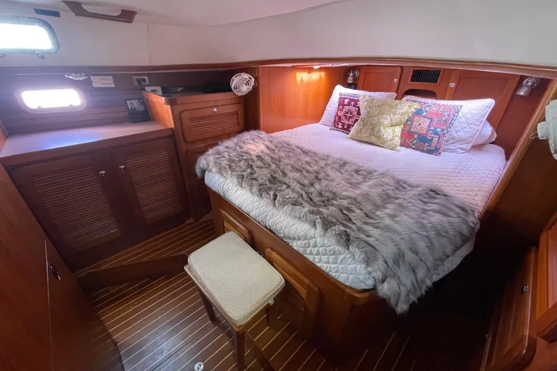 Peetee Hana Yacht Photos Pics Luxurious cabin interior of 2008 Caliber center cockpit cutter with cozy bedding and wood finish.
