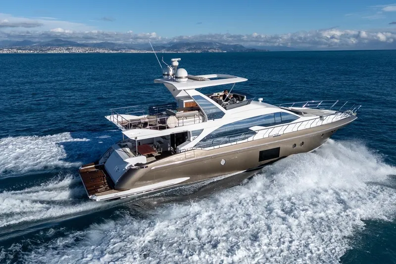 Ombretta V Yacht Photos Pics Luxury 2016 Azimut 66 yacht cruising on open sea, clear skies in background.