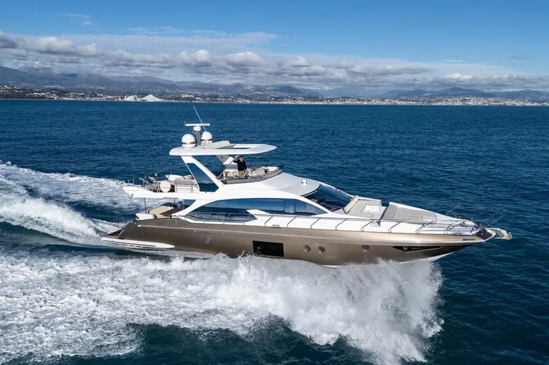 Ombretta V Yacht Photos Pics Luxury 2016 Azimut 66 yacht cruising on open sea with scenic coastal backdrop.