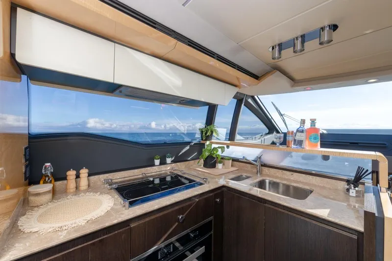 Ombretta V Yacht Photos Pics Luxurious kitchen interior of 2016 Azimut 66 yacht with ocean view.