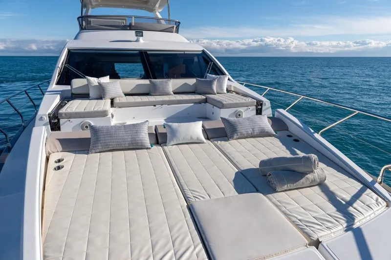 Ombretta V Yacht Photos Pics Luxurious 2016 Azimut 66 yacht with sunbathing deck, cushions, and ocean view.