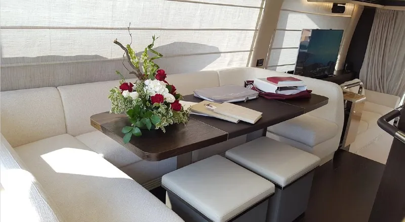 Ombretta Yacht Photos Pics Luxurious interior of 2017 Azimut 66 yacht with elegant dining area and floral centerpiece.