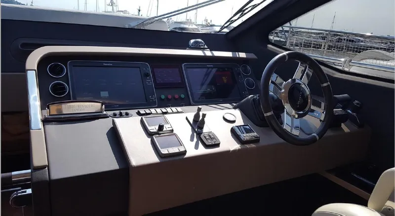 Ombretta Yacht Photos Pics Helm of 2017 Azimut 66 yacht with modern navigation controls and steering wheel.