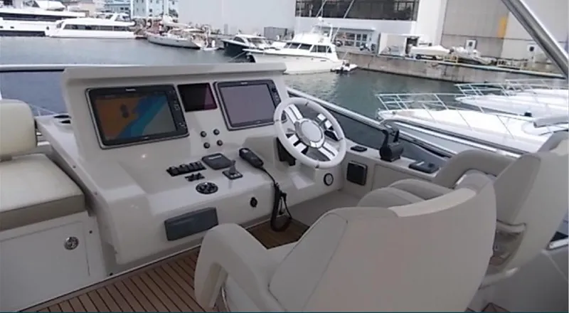 Ombretta Yacht Photos Pics Helm of 2017 Azimut 66 yacht with modern navigation equipment and steering wheel.