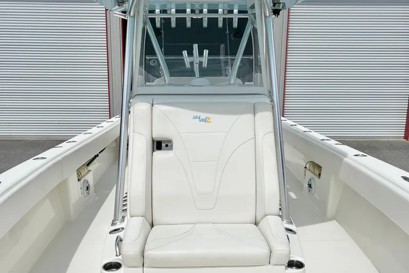 Yacht Photos Pics 2021 SeaVee 340Z boat interior with white seating and console, docked near storage units.