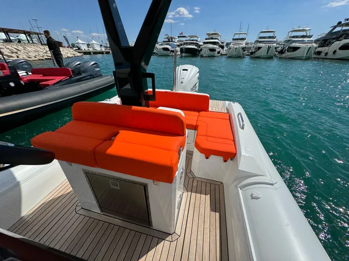  Yacht Photos Pics 2025 SuperRib Open 27 boat with orange seating, docked at a marina.
