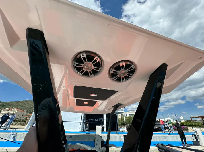  Yacht Photos Pics SuperRib Open 27 boat 2025 model, rear view with speakers, docked under blue sky.