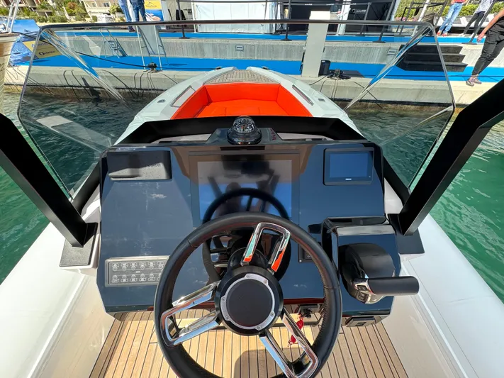  Yacht Photos Pics Cockpit view of 2025 SuperRib Open 27 boat with modern steering and controls.