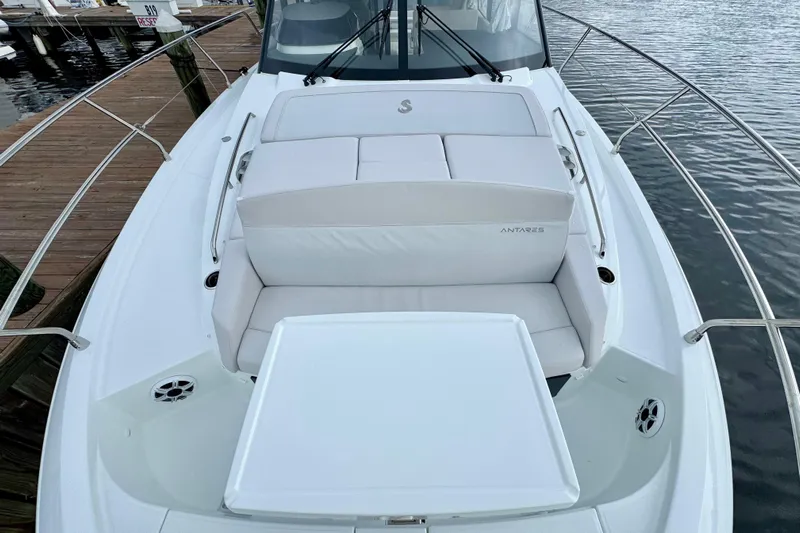  Yacht Photos Pics 2026 Beneteau Antares 12 boat with white cushioned seating on deck.