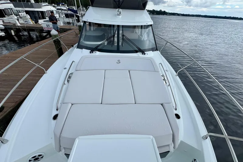  Yacht Photos Pics 2026 Beneteau Antares 12 yacht with spacious deck, docked at marina.