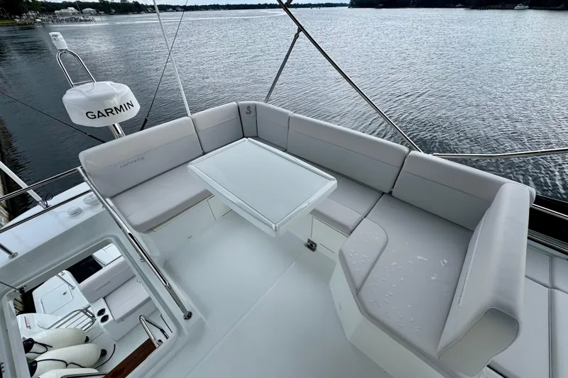  Yacht Photos Pics 2026 Beneteau Antares 12 yacht with spacious seating and Garmin equipment on a serene lake.