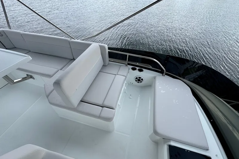  Yacht Photos Pics 2026 Beneteau Antares 12 boat deck with cushioned seating and water view.