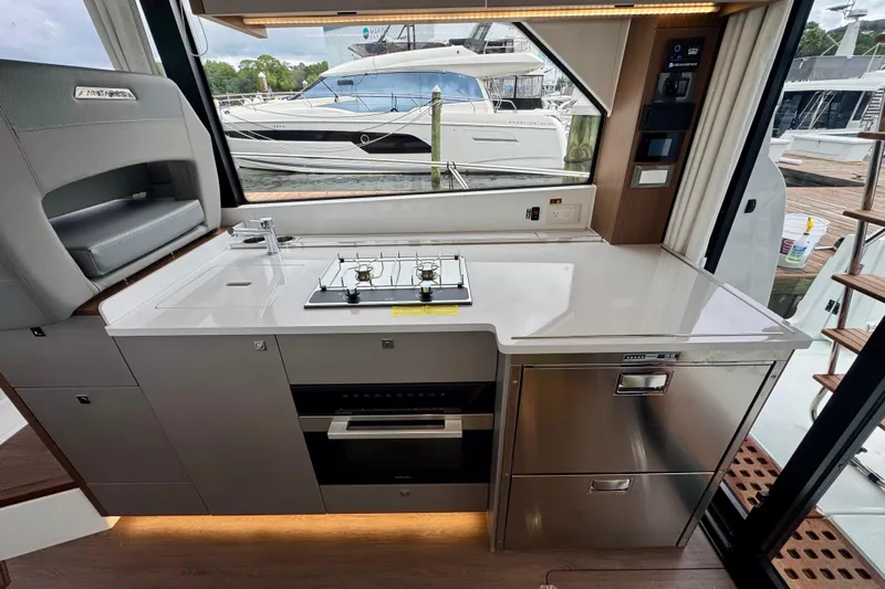  Yacht Photos Pics Modern kitchen area in 2026 Beneteau Antares 12 yacht, featuring sleek appliances and elegant design.