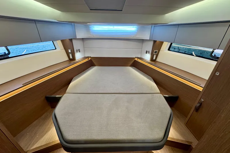  Yacht Photos Pics 2026 Beneteau Antares 12 cabin interior with modern design and comfortable bedding.