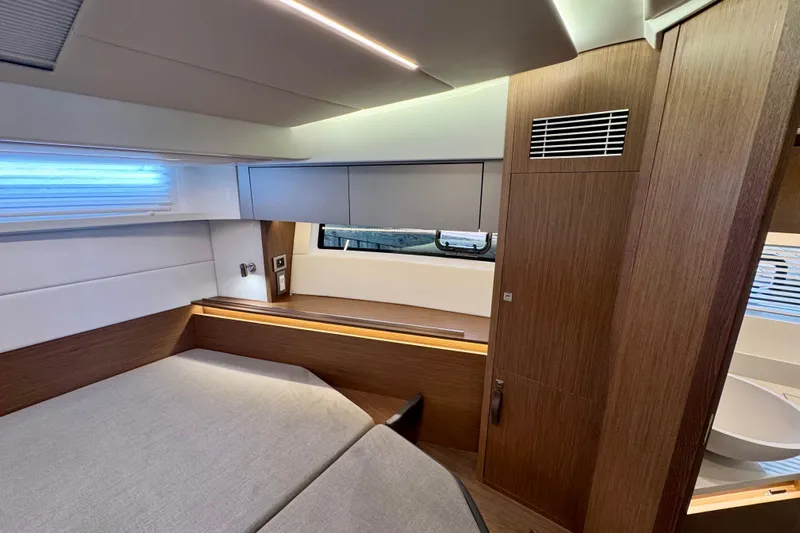  Yacht Photos Pics Luxurious interior of 2026 Beneteau Antares 12 yacht, featuring modern wood finishes and ambient lighting.