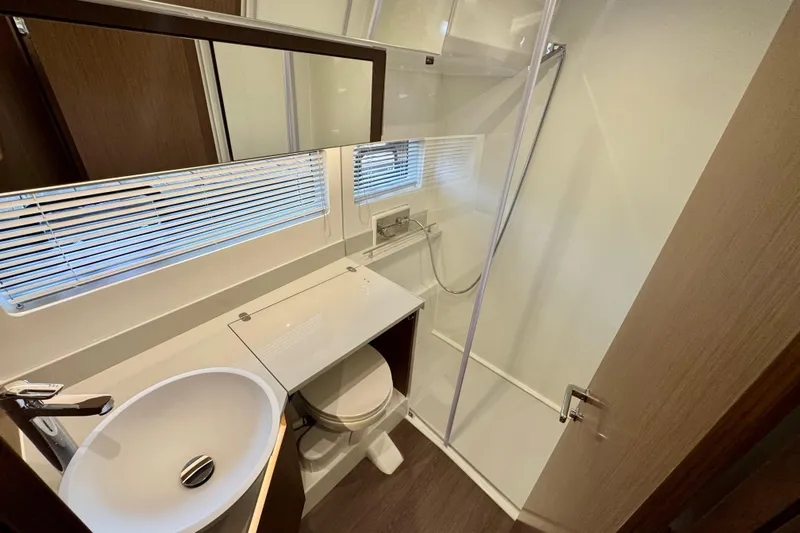 Yacht Photos Pics Modern bathroom in 2026 Beneteau Antares 12 yacht with shower and sink.
