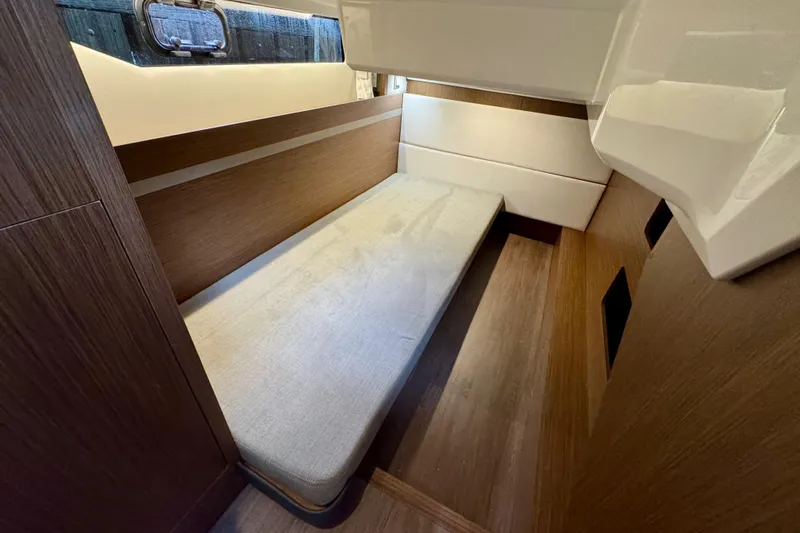  Yacht Photos Pics 2026 Beneteau Antares 12 cabin interior with wooden finish and single bed.