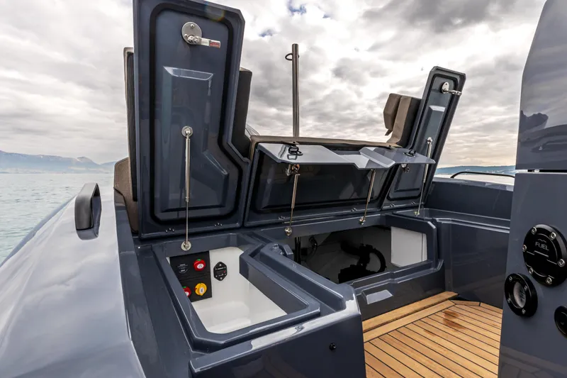  Yacht Photos Pics 2026 SuperRib Open 27 boat interior with open storage compartments and wooden deck.