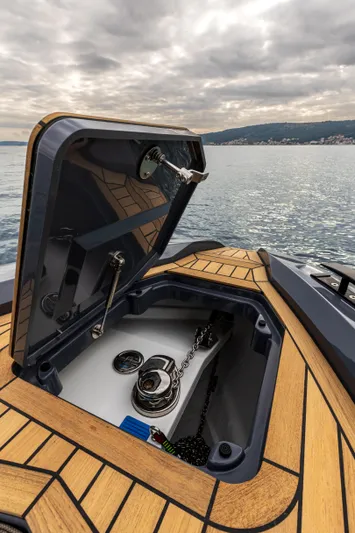  Yacht Photos Pics 2026 SuperRib Open 27 boat with open storage compartment on a calm sea.