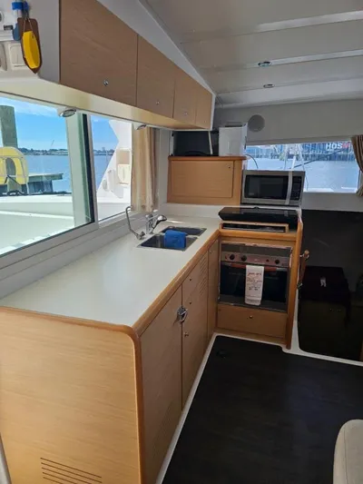 Moondance Yacht Photos Pics Modern kitchen interior of 2008 Lagoon 420 catamaran with appliances and waterfront view.