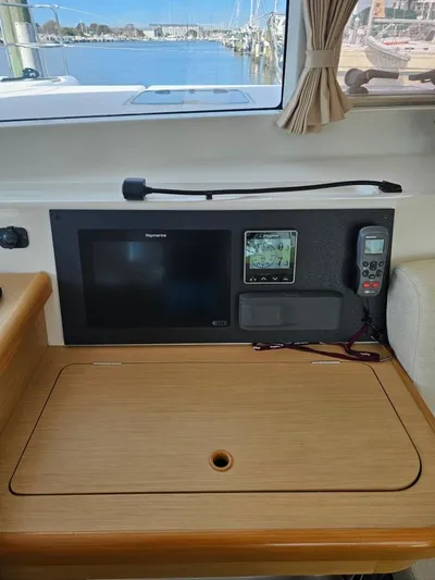 Moondance Yacht Photos Pics Navigation station on 2008 Lagoon 420 catamaran with electronics and scenic marina view.