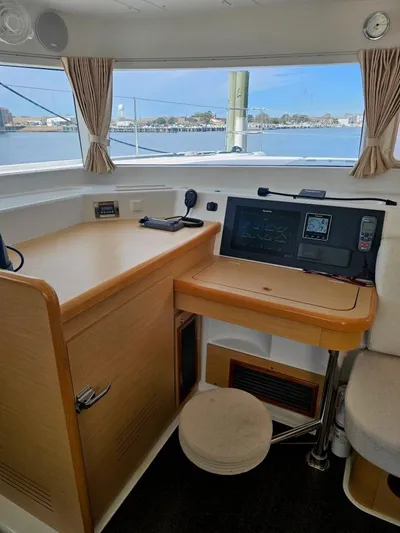 Moondance Yacht Photos Pics Interior helm of 2008 Lagoon 420 catamaran with navigation equipment and waterfront view.