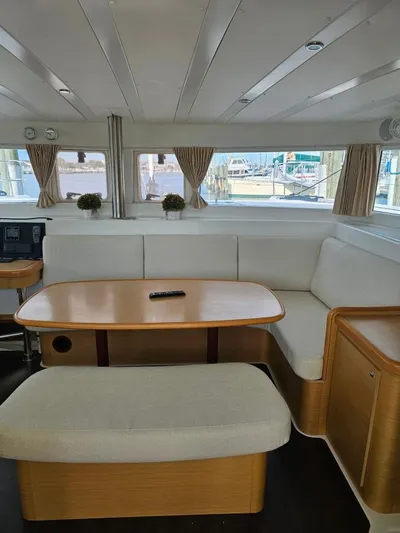 Moondance Yacht Photos Pics Interior of 2008 Lagoon 420 yacht with cozy seating and wooden table.