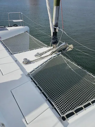 Moondance Yacht Photos Pics 2008 Lagoon 420 catamaran deck with netting over calm water.