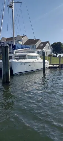 Moondance Yacht Photos Pics 2008 Lagoon 420 catamaran docked near waterfront homes.
