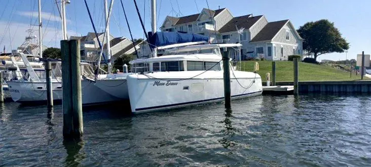 Moondance Yacht Photos Pics 2008 Lagoon 420 catamaran docked near waterfront homes.