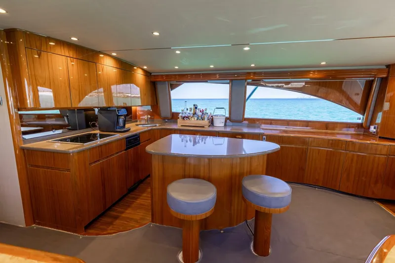 Gas Money Yacht Photos Pics Luxurious kitchen interior of 2015 Viking 62 Convertible yacht with ocean view.