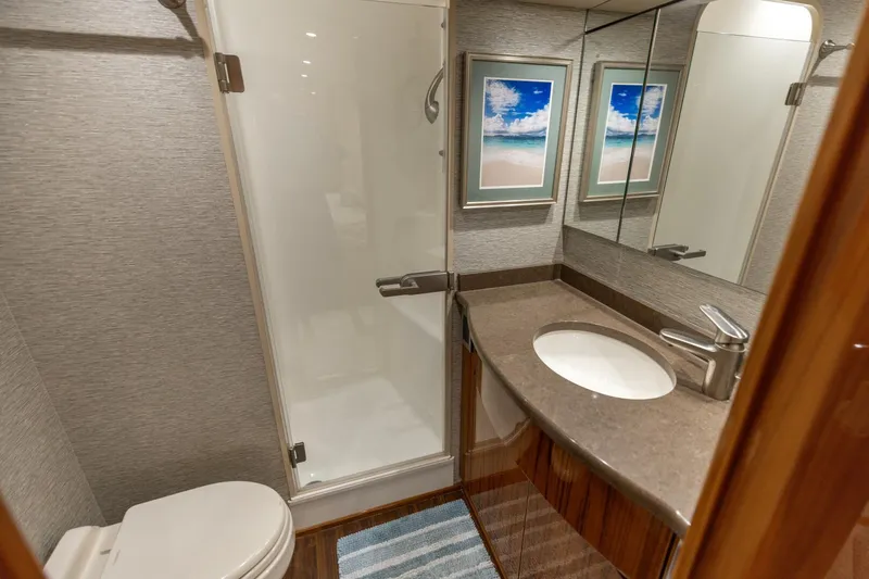 Gas Money Yacht Photos Pics Luxurious bathroom in 2015 Viking 62 Convertible yacht with modern fixtures and elegant decor.