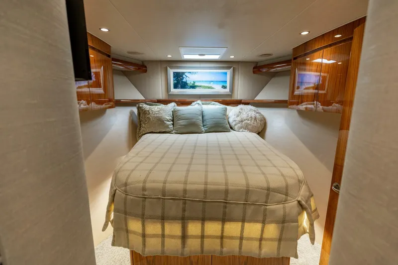 Gas Money Yacht Photos Pics Luxurious bedroom interior of 2015 Viking 62 Convertible yacht with cozy bedding.