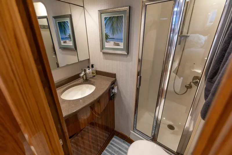 Gas Money Yacht Photos Pics Luxurious bathroom in 2015 Viking 62 Convertible yacht with shower and vanity.