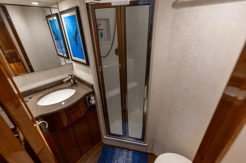 Gas Money Yacht Photos Pics Bathroom interior of 2015 Viking 62 Convertible yacht with shower and sink.