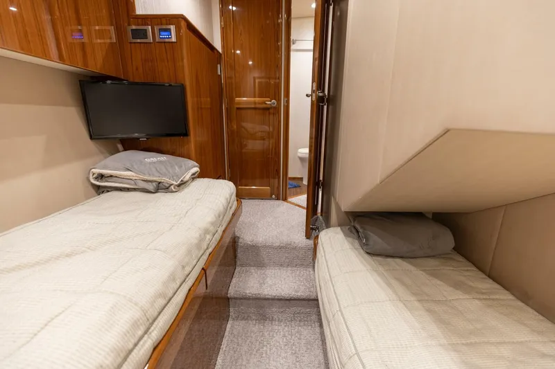 Gas Money Yacht Photos Pics Interior of 2015 Viking 62 Convertible yacht with twin beds and TV.