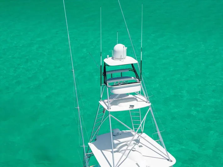 Gas Money Yacht Photos Pics 2015 Viking 62 Convertible yacht tower against clear turquoise water.