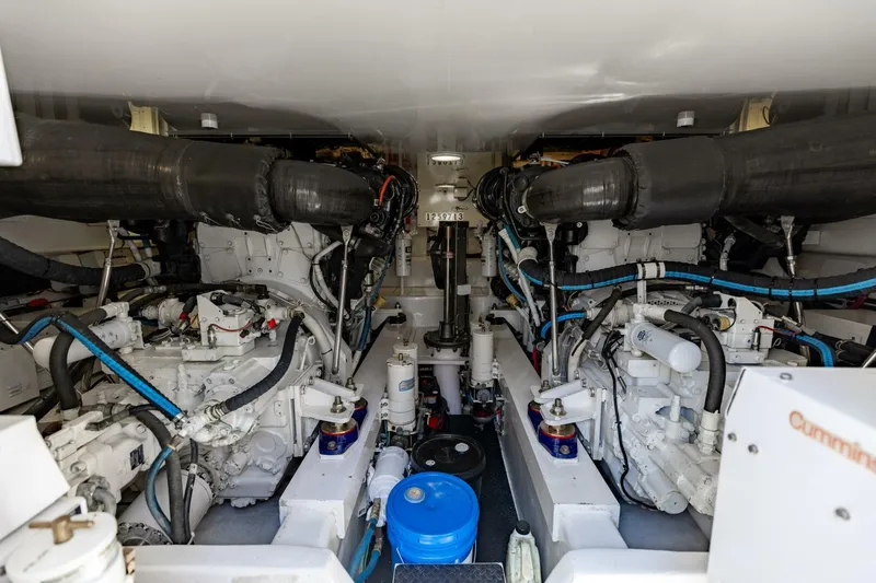 Gas Money Yacht Photos Pics Engine room of 2015 Viking 62 Convertible yacht, showcasing dual engines and mechanical components.