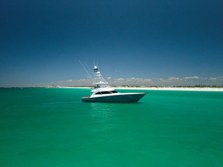 Gas Money Yacht Photos Pics 2015 Viking 62 Convertible yacht on turquoise waters under clear blue sky.