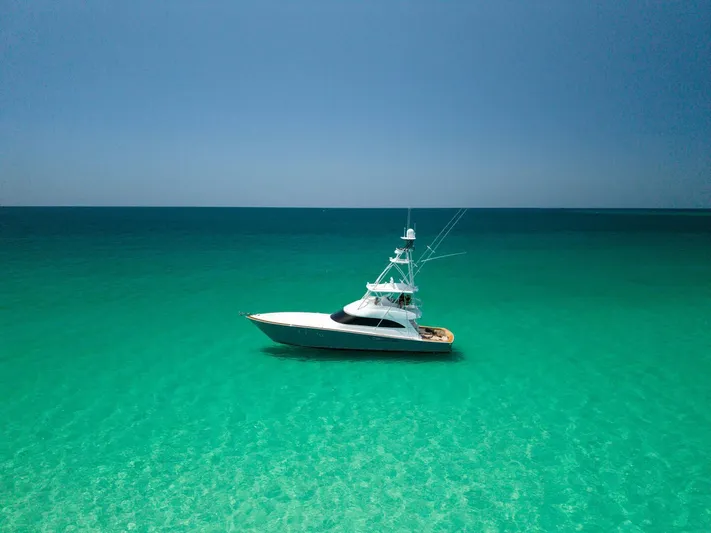 Gas Money Yacht Photos Pics Viking 62 Convertible yacht, 2015 model, in clear turquoise ocean waters.