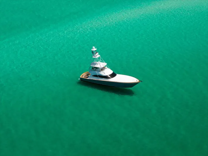 Gas Money Yacht Photos Pics 2015 Viking 62 Convertible yacht on clear turquoise water.