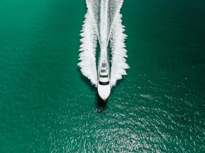 Gas Money Yacht Photos Pics Aerial view of 2015 Viking 62 Convertible yacht cruising on turquoise water.