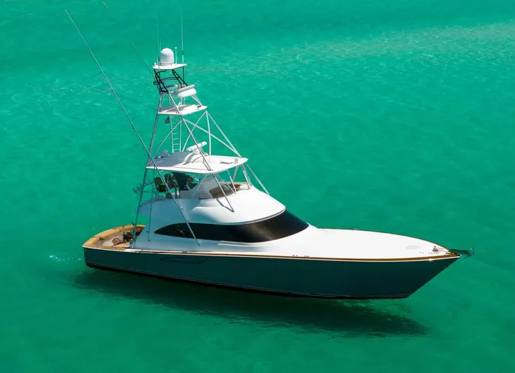 Gas Money Yacht Photos Pics 2015 Viking 62 Convertible yacht cruising on turquoise waters.