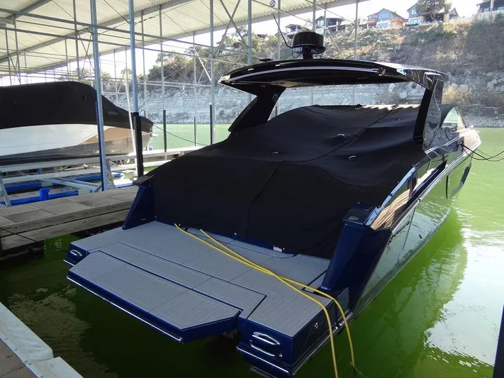  Yacht Photos Pics 2021 Cruisers Yachts 38 GLS I/O docked, covered, in a marina setting.