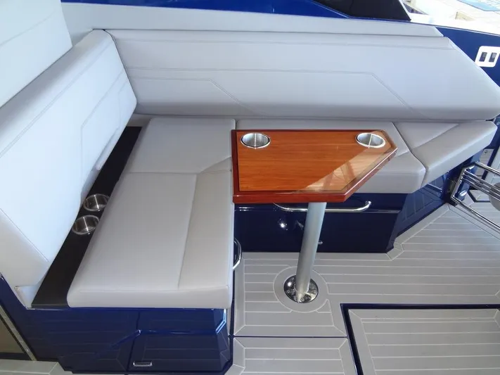  Yacht Photos Pics 2021 Cruisers Yachts 38 GLS I/O interior seating with wooden table and cup holders.