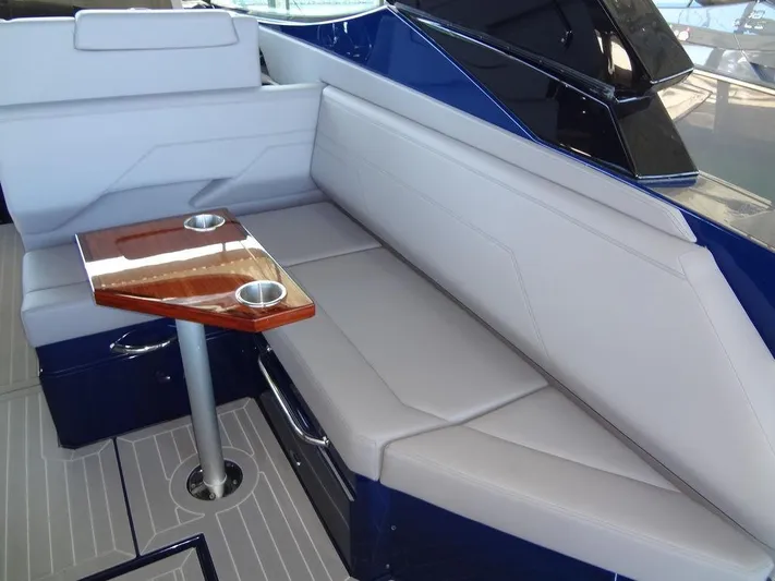  Yacht Photos Pics Interior seating area of 2021 Cruisers Yachts 38 GLS I/O with table and cup holders.